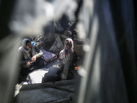 Displaced Palestinians are baking bread at a makeshift tent camp in Deir Al-Balah, Central Gaza Strip, on March 8, 2024, as battles are cont...
