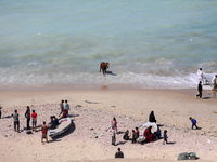 Palestinians are enjoying the beach in Deir Al-Balah, Central Gaza Strip, on March 8, 2024, while battles are continuing between Israel and...