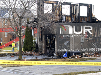 Demolition crews are waiting on the street in front of a home that was destroyed by a reported explosion and fire in Brampton, Ontario, Cana...