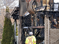 A demolition crew member is watching as a home is being torn down following its destruction by a reported explosion and fire in Brampton, On...