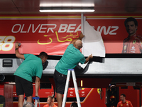 Workers install Oliver Bearman sign instead of Carlos Sainz on Ferrari garage before qualifying ahead of the Formula 1 Saudi Arabian Grand P...