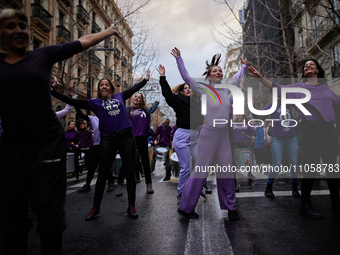 A group of protesters are dancing at the head of the demonstration in Granada, Spain, on March 8, 2024, during International Women's Day. In...