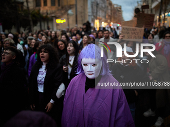 A protester is wearing a mask during the International Women's Day demonstration in Granada, Spain, on March 8, 2024. International Women's...