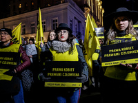 Women rights activists  from the Amnesty International hold banners human rights banners during a protest in front of the Presidential Palac...