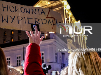Women rights activist from the Women's Hell organisation holds a banners 'Holownia Fuck Off' during a protest in front of the Presidential P...