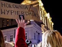 Women rights activist from the Women's Hell organisation holds a banners 'Holownia Fuck Off' during a protest in front of the Presidential P...