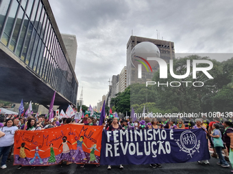 Women are participating in an event on International Women's Day on Avenida Paulista in Sao Paulo in the afternoon of Friday, March 8. (