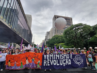 Women are participating in an event on International Women's Day on Avenida Paulista in Sao Paulo in the afternoon of Friday, March 8. (