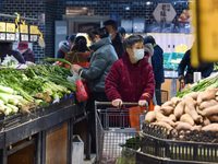 Citizens are shopping at a supermarket in Nanjing, East China's Jiangsu province, on March 9, 2024. China's consumer price index has risen 0...