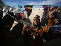 A displaced Palestinian girl is decorating her tent with Ramadan decorations in Deir al-Balah in the central Gaza Strip on March 9, 2024, am...