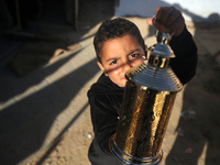 A Palestinian child is holding a Ramadan lantern in Deir al-Balah in the central Gaza Strip on March 9, 2024, amid the ongoing conflict betw...