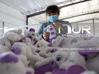 A worker is producing toys for export at a workshop of a toy company in Binzhou, Shandong Province, China, on March 10, 2024. (