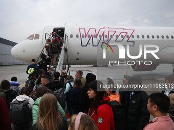 People board Wizz Air plane on the airport in Katowice, Poland on February 28, 2024. (