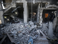 Palestinians are inspecting the damage at a home in Deir al-Balah in the central Gaza Strip on March 10, 2024, which has been hit during an...