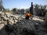 Palestinians are inspecting the damage at a home in Deir al-Balah in the central Gaza Strip on March 10, 2024, which has been hit during an...
