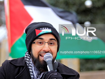 Anas Sial, the leader of the grassroots organization Action for Palestine, is speaking to a small crowd in Ken Whillans Square beside the ci...
