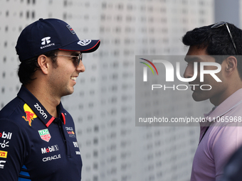 Sergio Perez of Red Bull Racing and Karun Chandhok before first practice ahead of the Formula 1 Saudi Arabian Grand Prix at Jeddah Corniche...