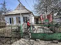 A woman is standing in the yard of her private house in Huliaipole, Zaporizhzhia Region, Ukraine, on March 7, 2024. NO USE RUSSIA. NO USE BE...