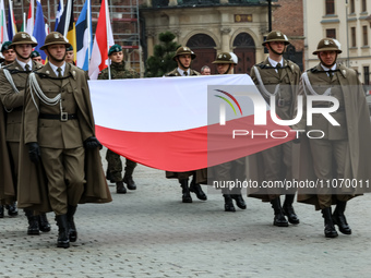 Polish soldiers hold Polish and NATO and NATO members' flags as they celebrate the 25. anniversary of Poland joining North Atlantic alliance...