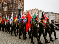 Polish soldiers hold NATO members' flags as they celebrate the 25. anniversary of Poland joining North Atlantic alliance in the Main Square...
