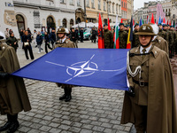 Polish soldiers hold NATO and NATO members' flags as they celebrate the 25. anniversary of Poland joining North Atlantic alliance in the Mai...
