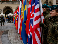 Polish soldiers hold NATO members' flags as they celebrate the 25. anniversary of Poland joining North Atlantic alliance in the Main Square...