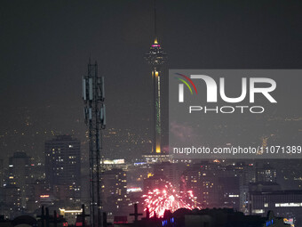 Fireworks are lighting up the sky under the Milad Telecommunications Tower in northwestern Tehran during the annual ''Chahar Shanbeh Soori,'...