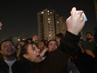A young Iranian woman is taking a selfie while participating in the annual ''Chahar Shanbeh Soori,'' also known as the fire festival, in nor...