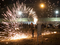 An Iranian man is performing with fire while participating in the annual ''Chahar Shanbeh Soori,'' also known as the fire festival, in north...
