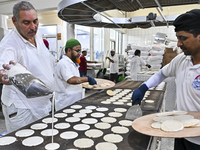 Vendors are preparing Qatayef, traditional pancakes that are popular during the Muslim fasting month of Ramadan, in Doha, Qatar, on March 12...