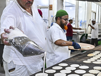 The vendor is preparing Qatayef, traditional pancakes that are popular during the Muslim fasting month of Ramadan, in Doha, Qatar, on March...