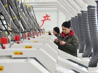 A worker is checking product quality in a digital intelligent production workshop at a hardware manufacturing company in Handan, North China...