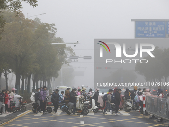 Primary school students are traveling in thick fog in Huai'an, China, on March 15, 2024. (