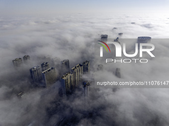 High-rise buildings are looming in advection fog in the Qingjiangpu district of Huai'an city, Jiangsu province, China, on March 15, 2024. (
