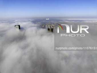 High-rise buildings are looming in advection fog in the Qingjiangpu district of Huai'an city, Jiangsu province, China, on March 15, 2024. (