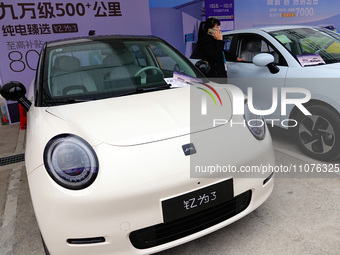 Citizens are looking at new energy vehicles on display at an auto show in Yichang, Hubei Province, China, on March 15, 2024. Data released b...