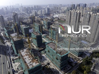 A commercial housing complex is under construction and for sale in downtown Huai'an, East China's Jiangsu province, on March 15, 2024. (