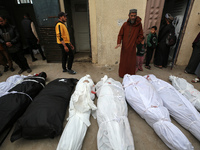 Palestinians are mourning their relatives, who were killed in an overnight Israeli strike on the Nuseirat refugee camp, during a mass funera...
