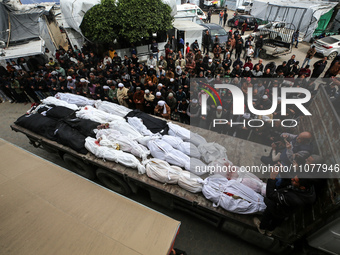 Palestinians are praying over the shrouded bodies of loved ones who were killed during an Israeli bombardment in Deir Al-Balah, in the centr...