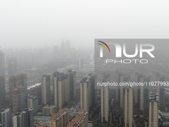 City buildings are looming under smog in Xi'an, Shaanxi Province, China, on March 16, 2024. (
