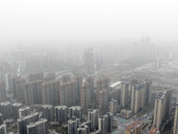 City buildings are looming under smog in Xi'an, Shaanxi Province, China, on March 16, 2024. (