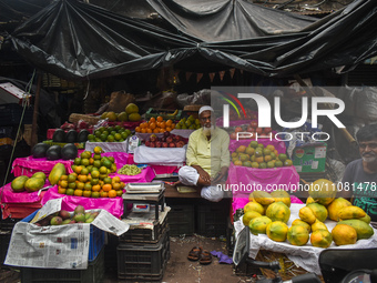 Fruit sellers are waiting for their customers inside a wholesale market during Ramadan in Kolkata, India, on March 17, 2023. (