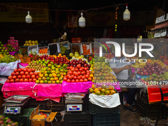 A fruit seller is waiting for his customers inside a wholesale market during Ramadan in Kolkata, India, on March 17, 2023. (