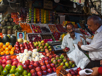 A person is bargaining with a fruit seller inside a wholesale market during Ramadan in Kolkata, India, on March 17, 2023. (