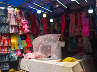 A person is arranging ladies' garments inside his stall for sale during Ramadan in Kolkata, India, on March 17, 2023. (