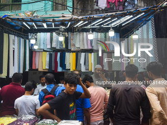 People are buying garments from a garment shop during Ramadan in Kolkata, India, on March 17, 2023. (