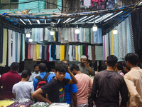 People are buying garments from a garment shop during Ramadan in Kolkata, India, on March 17, 2023. (