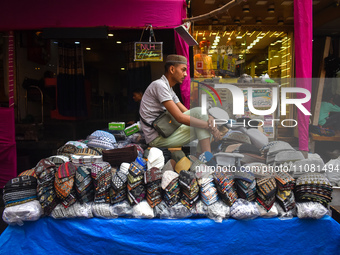 A person is selling Taqiyahs (Muslim skull caps) during Ramadan in Kolkata, India, on March 17, 2023. (