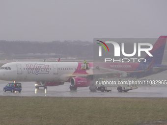 A Wizz Air airplane is undergoing deicing on the ground in Gdansk, Poland, on March 17, 2024. (