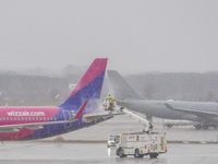 A Wizz Air airplane is undergoing deicing on the ground in Gdansk, Poland, on March 17, 2024. (